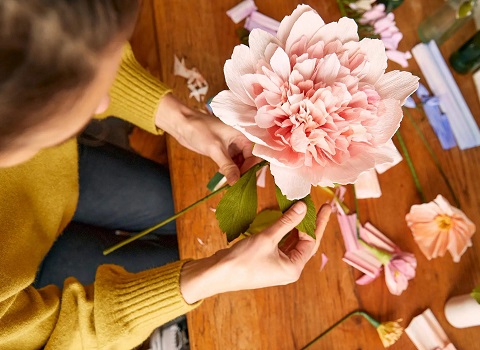Twisting crepe paper to create colorful blooms